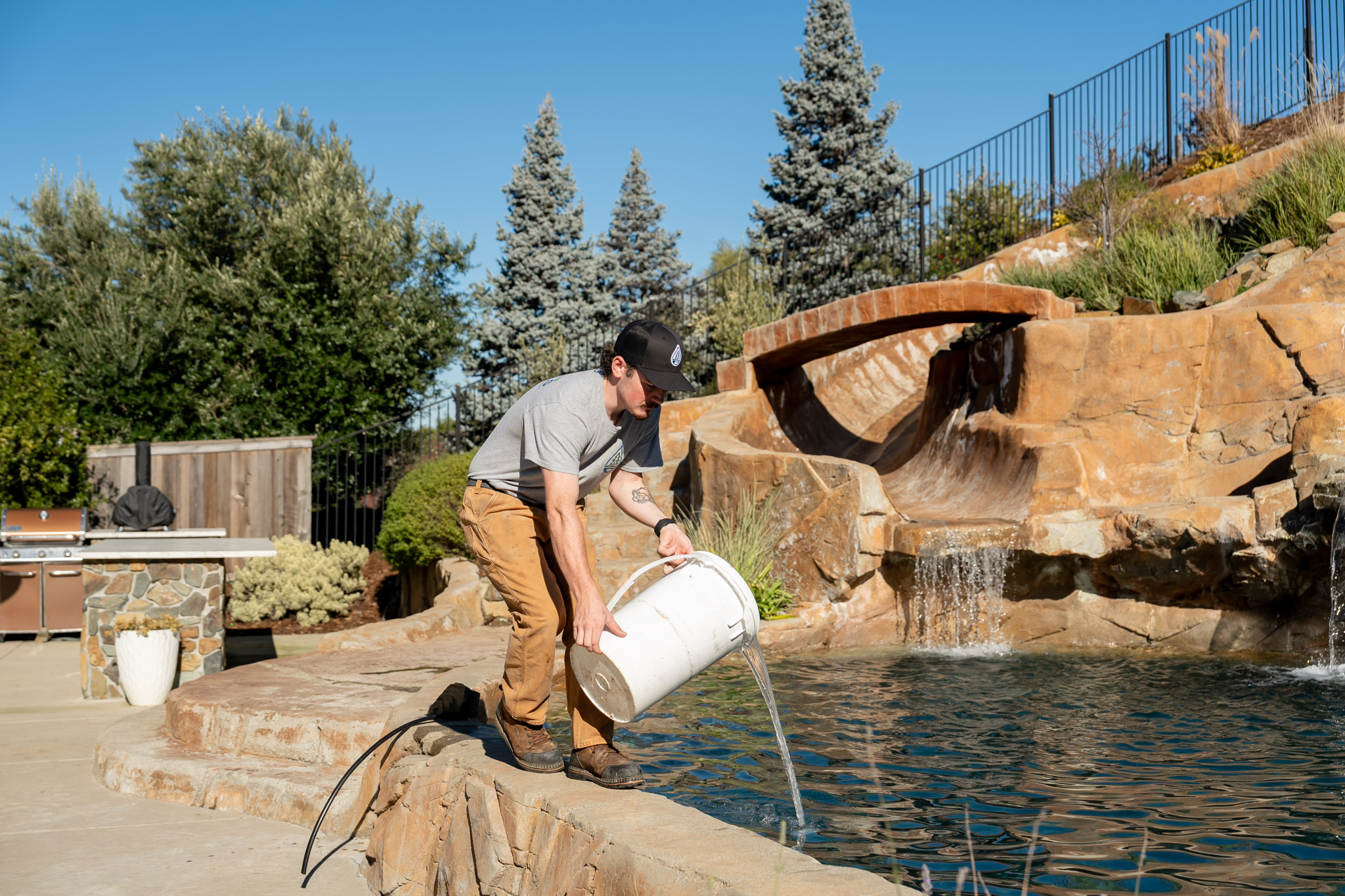 Pool Ninja tech treating a green pool with chemicals