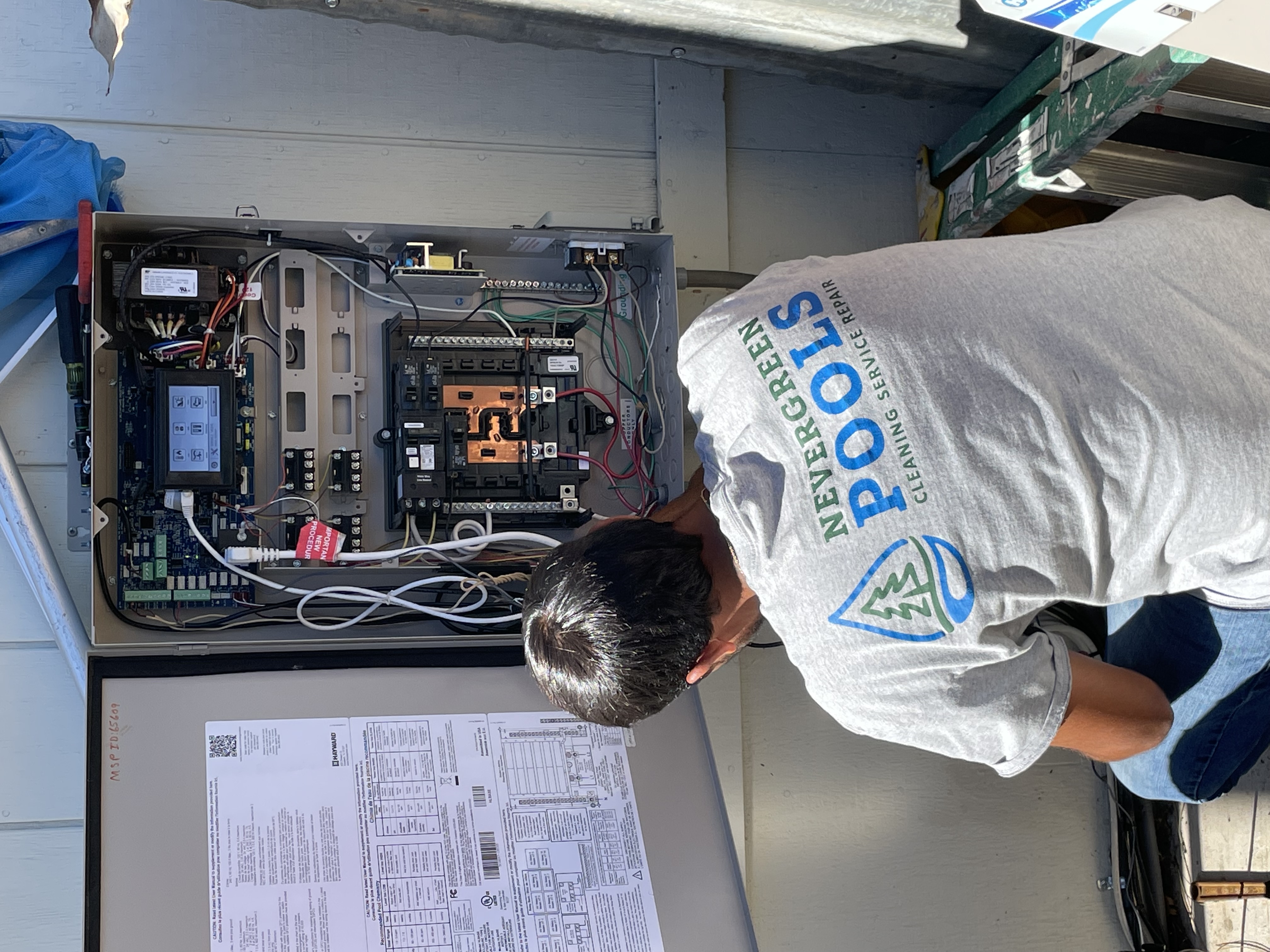 Pool Ninja tech inspecting pool equipment