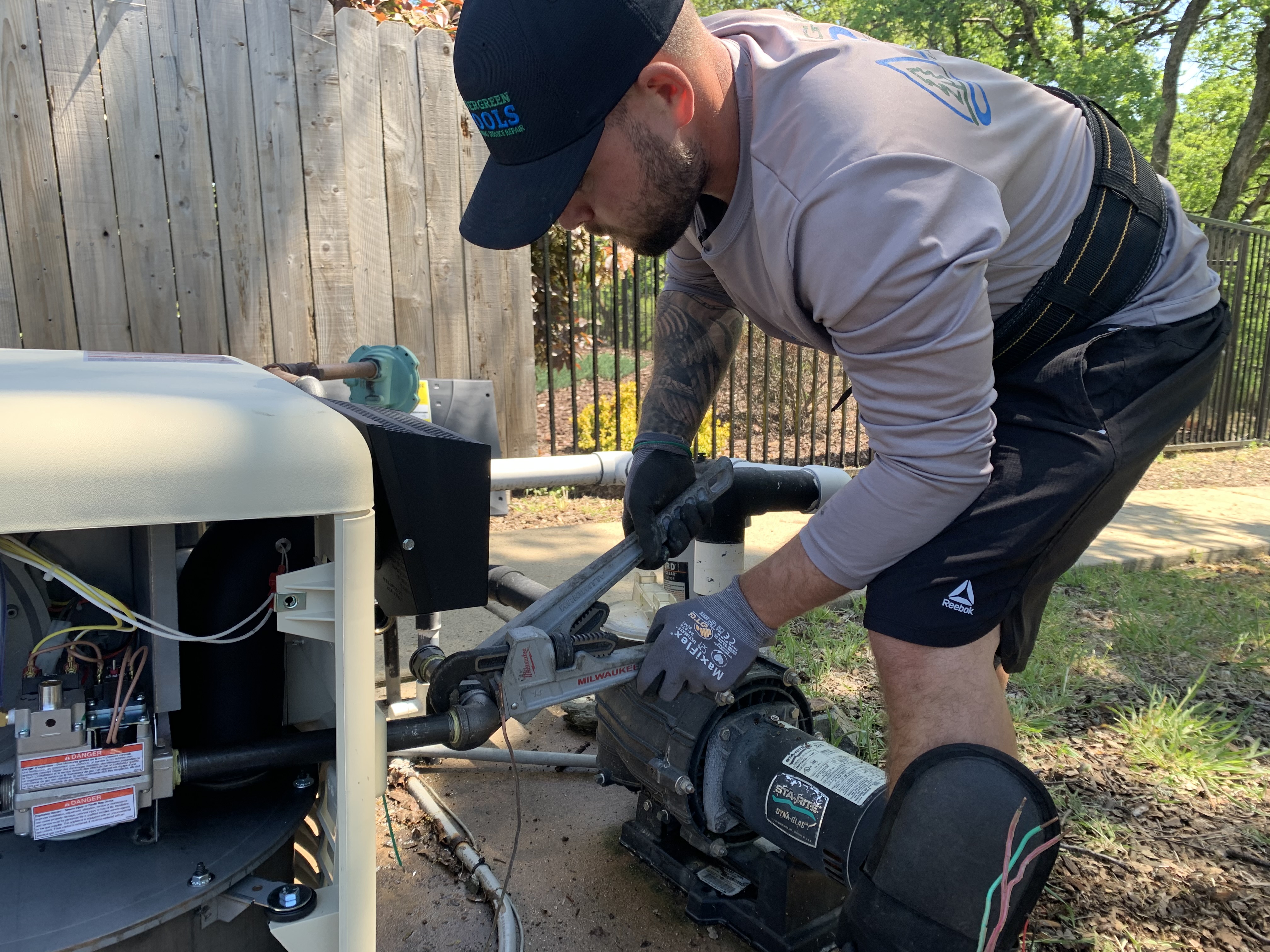 Pool Ninja tech servicing pool equipment with hose